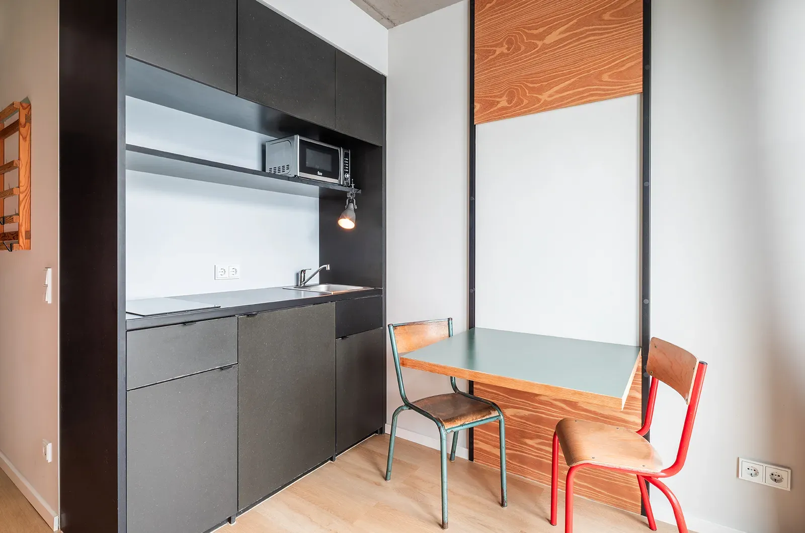 Undecorated kitchen in a Classic Balcony Room at Neon Wood Berlin Frankfurter Tor showing furnished baseline without styling accents
