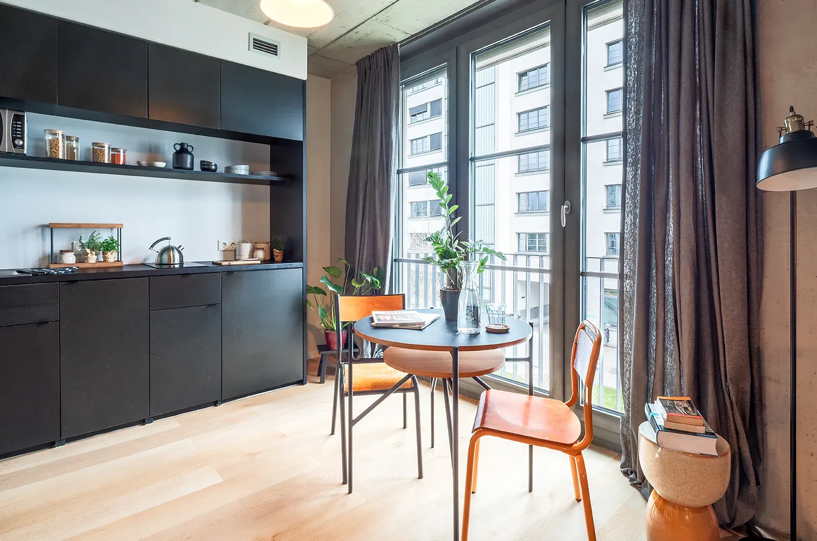 Styled kitchen and dining area in a Deluxe Balcony Room at Neon Wood Berlin Frankfurter Tor showing decorated space and personalization example