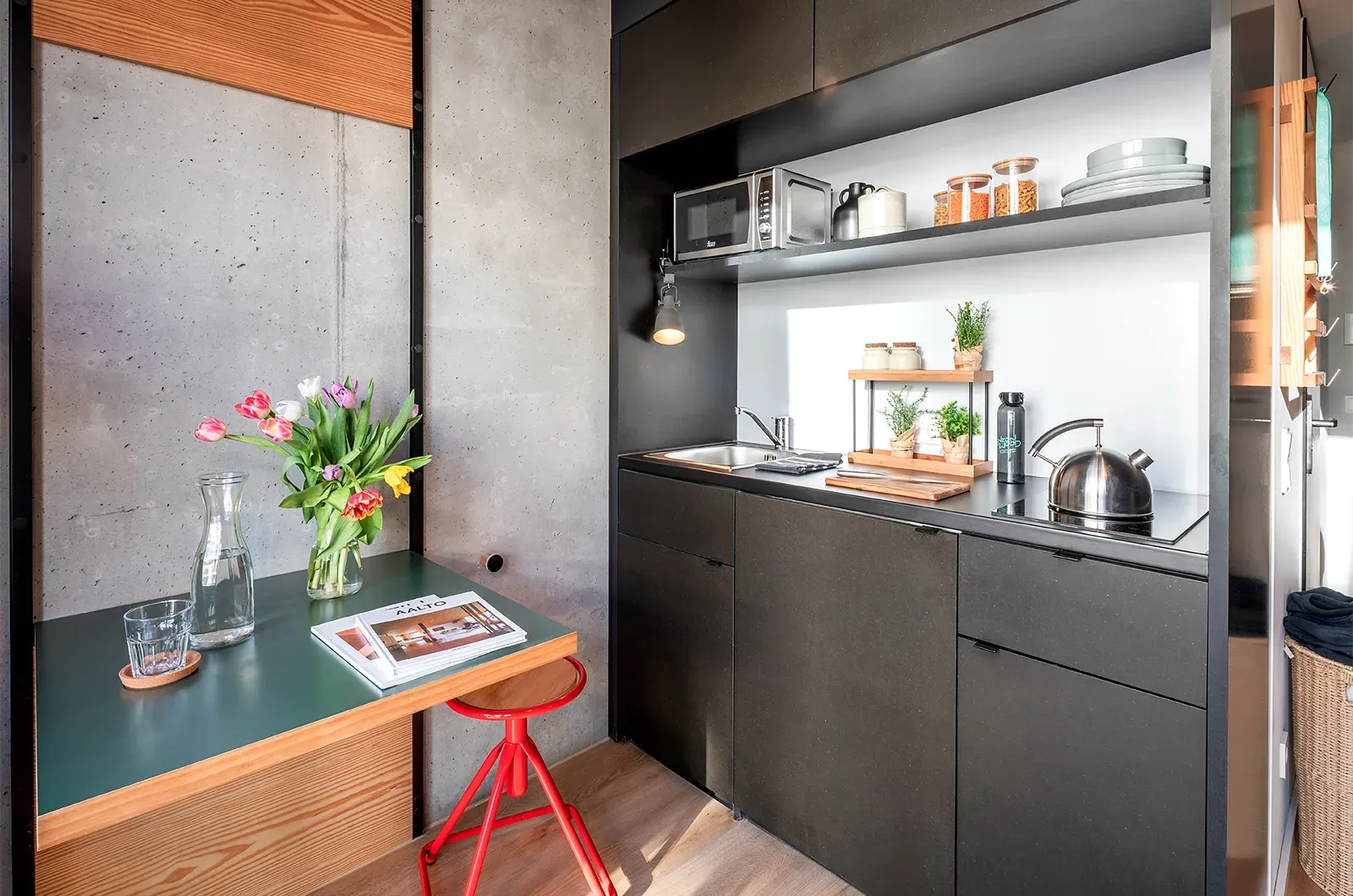 Styled kitchenette and foldable table in a Classic Room at Neon Wood Berlin Mitte-Wedding showing decorated space and personalization example