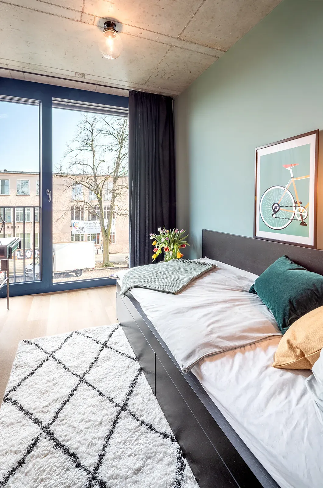 Styled bed area in a Deluxe Room at Neon Wood Berlin Mitte-Wedding showing decorated sleeping space and personalization example