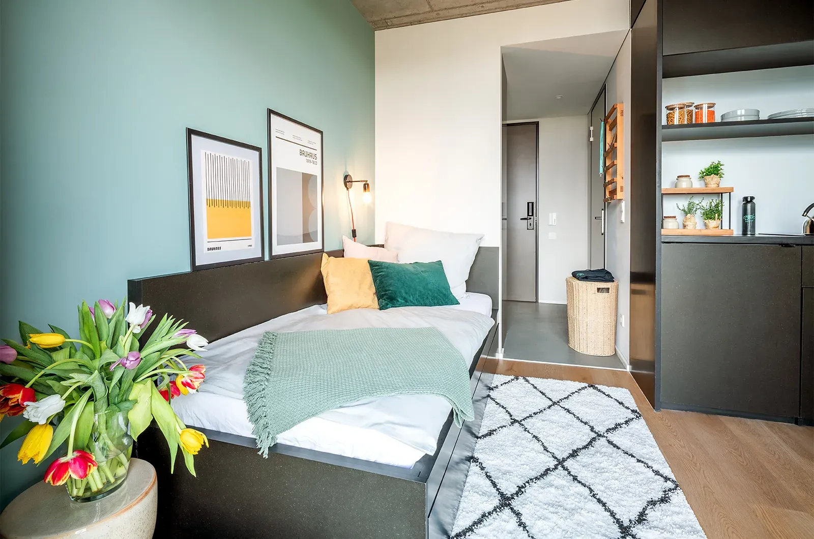 Styled bed and entrance area in a Deluxe Balcony Room at Neon Wood Berlin Mitte-Wedding showing decorated space and personalization example