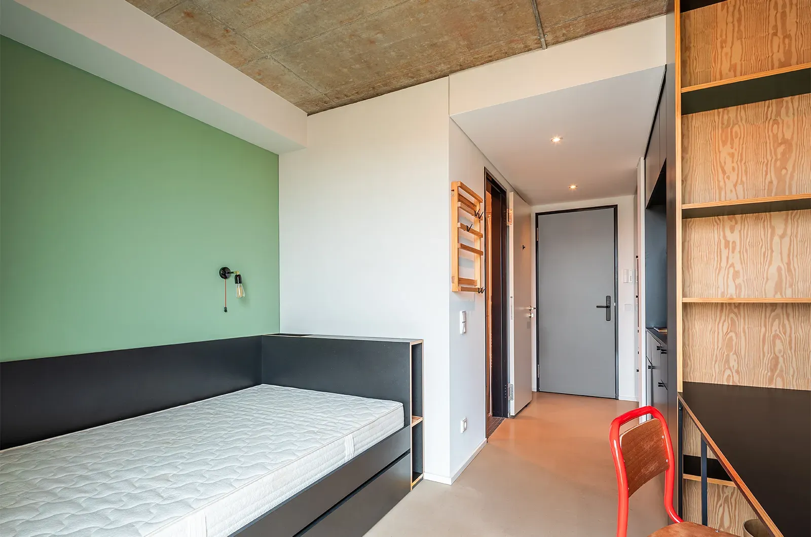 Undecorated bed and entrance area in a room at Neon Wood Frankfurt Riedberg showing furnished baseline without styling accents