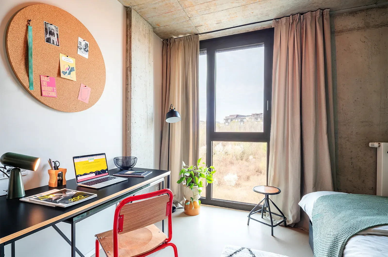 Styled desk area with window view in a room at Neon Wood Frankfurt Riedberg showing decorated workspace and personalization example