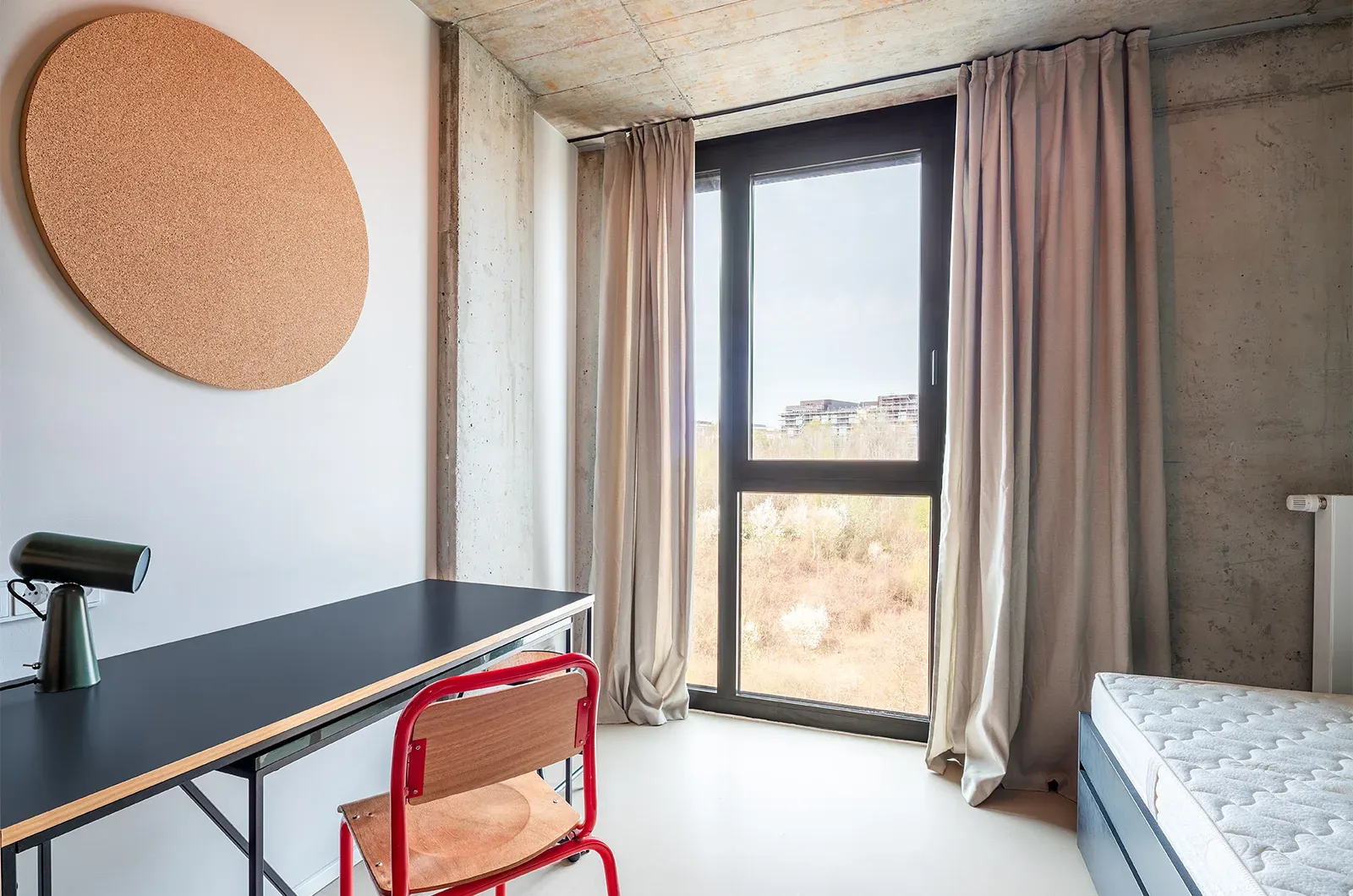 Undecorated desk area with window view in a room at Neon Wood Frankfurt Riedberg showing furnished baseline without styling accents