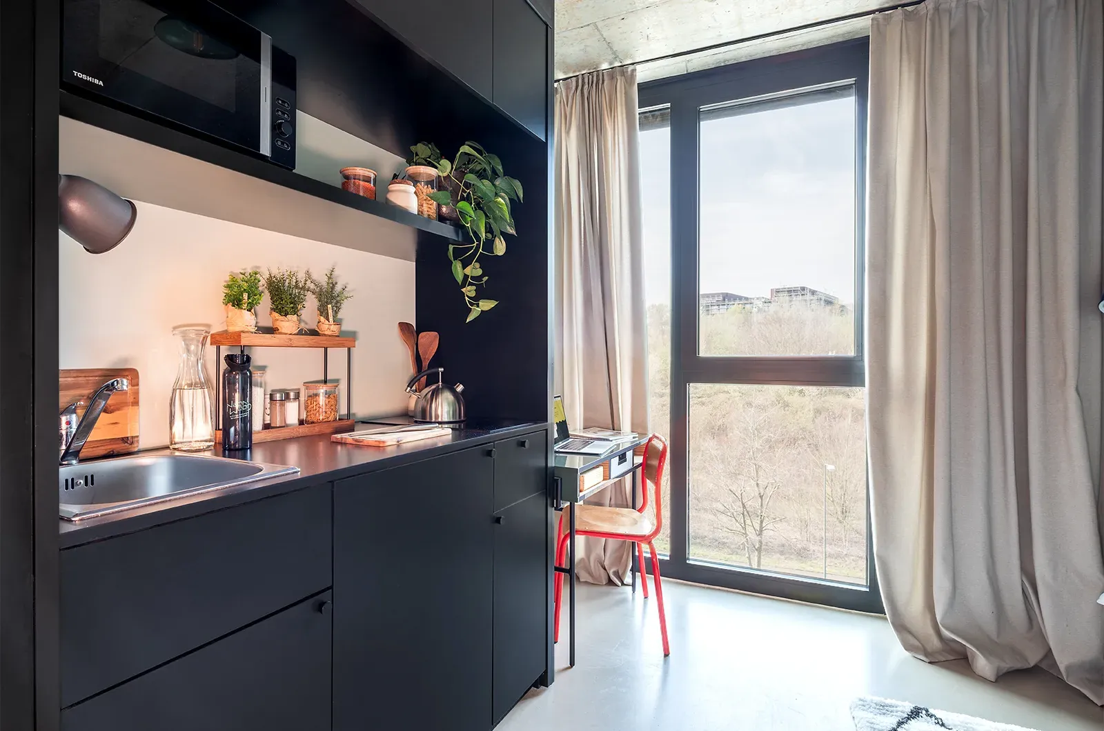 Styled kitchen in a Classic Deluxe Room at Neon Wood Frankfurt Riedberg showing decorated space and personalization example