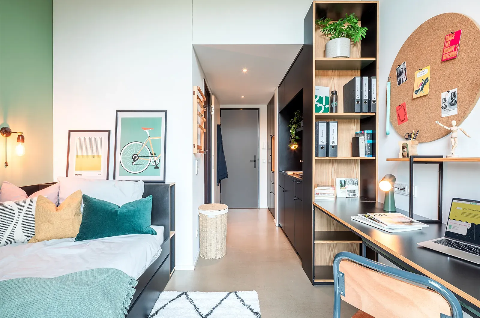 Styled bed area, desk, storage and entrance in a Patio Room at Neon Wood Frankfurt Riedberg showing decorated space and personalization example